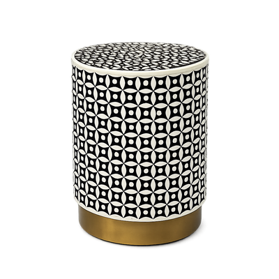 Round side table with black and white geometric pattern and gold base on a white background