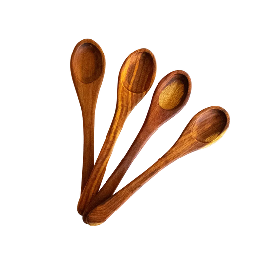 A set of four wooden table spoons with a smooth finish, displayed on a light background.